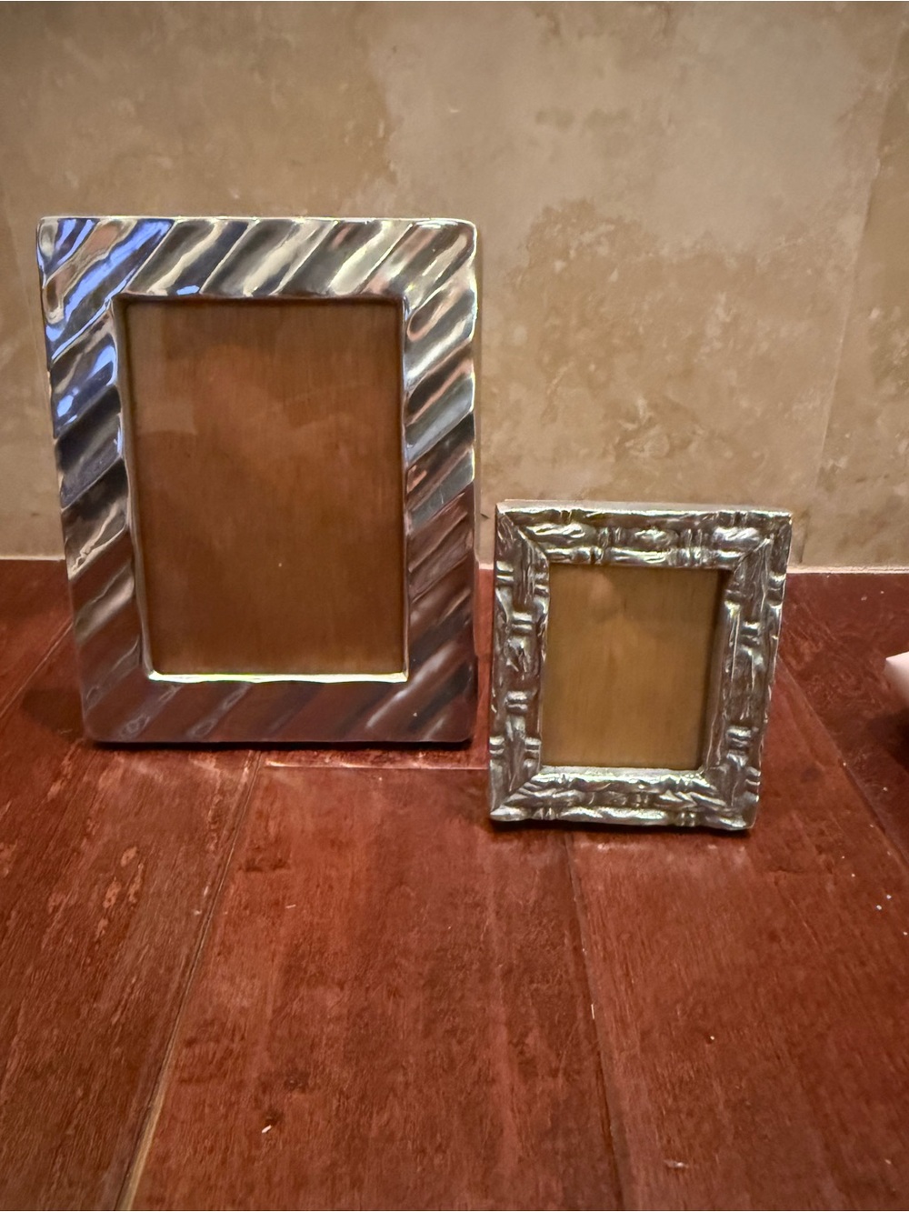 Set of two pewter frames with wooden back easel.